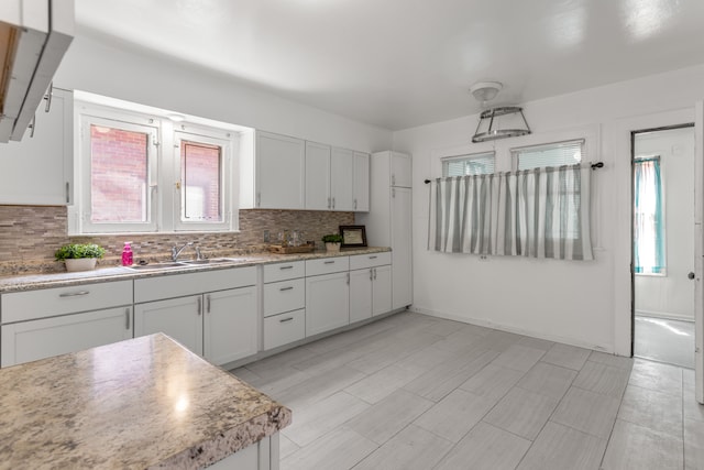 8735 Marygrove Dr, Detroit, MI 48221 - kitchen with light countertops, tasteful backsplash, a healthy amount of sunlight, and a sink