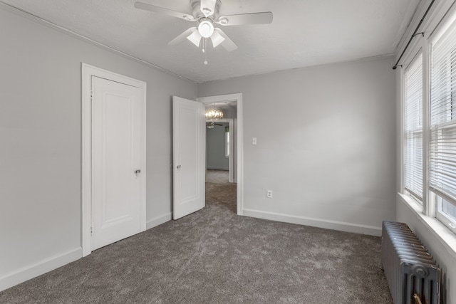 8735 Marygrove Dr, Detroit, MI 48221 - unfurnished bedroom featuring a ceiling fan, radiator heating unit, baseboards, and carpet flooring