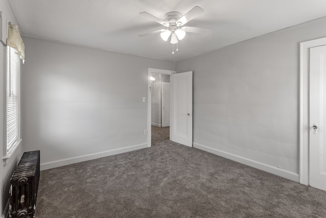 8735 Marygrove Dr, Detroit, MI 48221 - unfurnished bedroom with carpet floors, radiator heating unit, ceiling fan, and baseboards