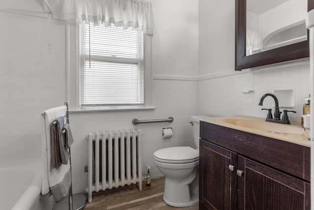 8735 Marygrove Dr, Detroit, MI 48221 - full bath featuring tile walls, toilet, radiator, vanity, and wood finished floors
