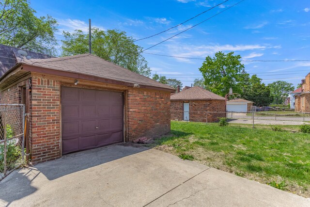 8735 Marygrove Dr, Detroit, MI 48221 - detached garage featuring concrete driveway and fence