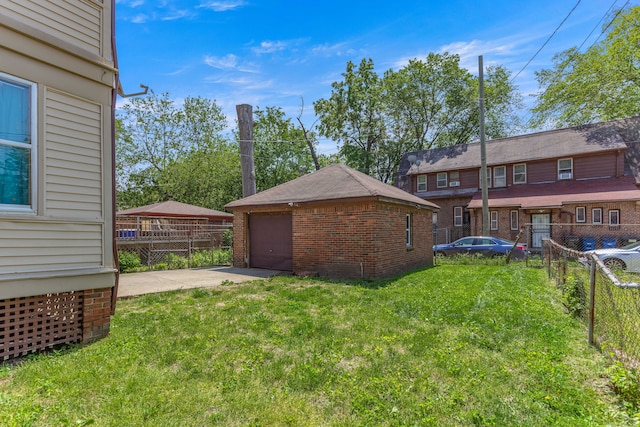 8735 Marygrove Dr, Detroit, MI 48221 - view of yard featuring concrete driveway, an outdoor structure, fence, and a garage