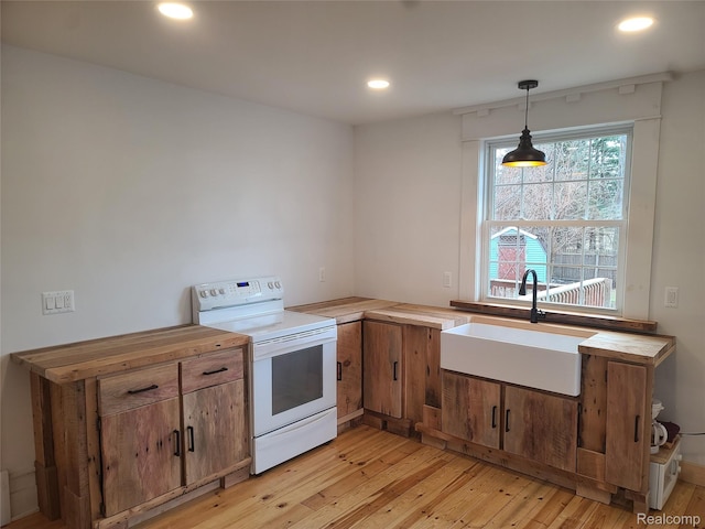 3685 Main St, Akron, MI 48701 - kitchen featuring white electric range, a sink, light wood-style flooring, recessed lighting, and decorative light fixtures