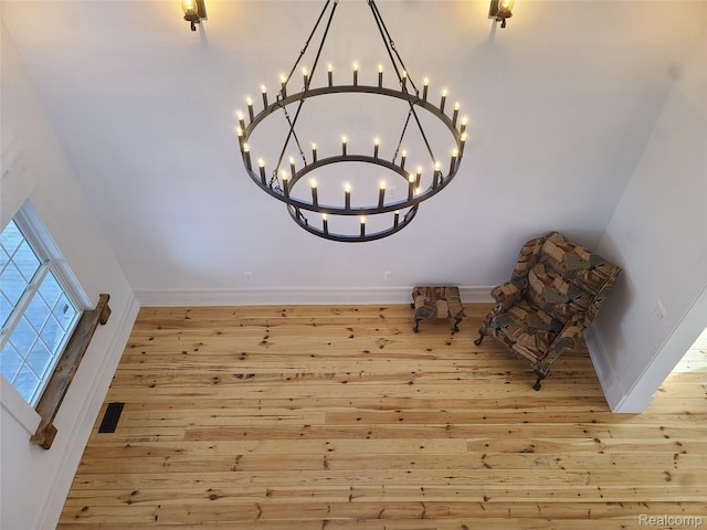 3685 Main St, Akron, MI 48701 - unfurnished room with hardwood / wood-style flooring, baseboards, and a chandelier