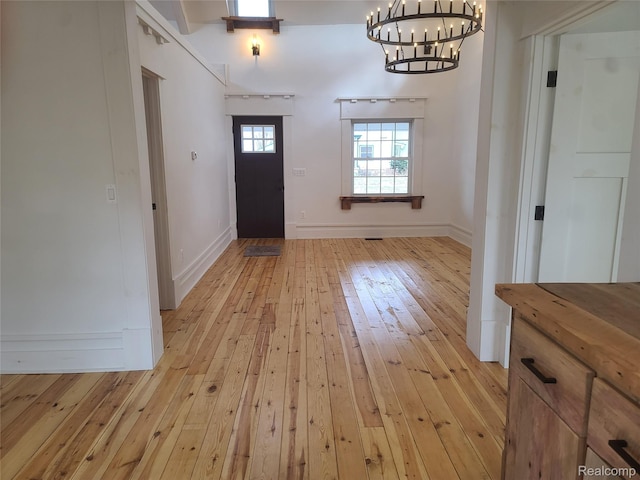 3685 Main St, Akron, MI 48701 - entrance foyer featuring a chandelier, light wood-style flooring, and baseboards