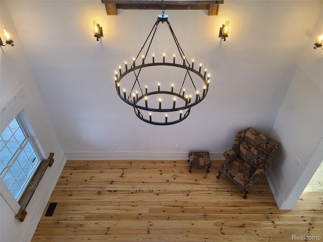 3685 Main St, Akron, MI 48701 - unfurnished room with hardwood / wood-style floors, a chandelier, baseboards, and beamed ceiling