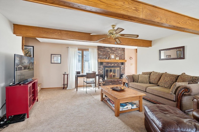 carpeted living area with baseboards, ceiling fan, beam ceiling, and a brick fireplace