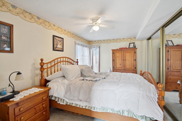 carpeted bedroom with a closet and a ceiling fan