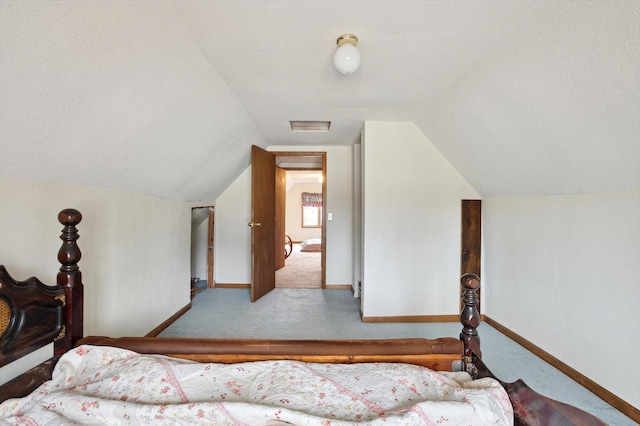 bedroom featuring carpet flooring, baseboards, lofted ceiling, and a textured ceiling