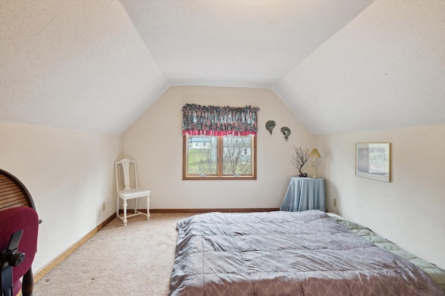 bedroom featuring carpet, vaulted ceiling, and a textured ceiling