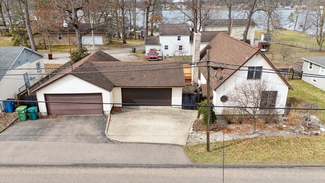 view of front of home featuring a residential view, driveway, and fence