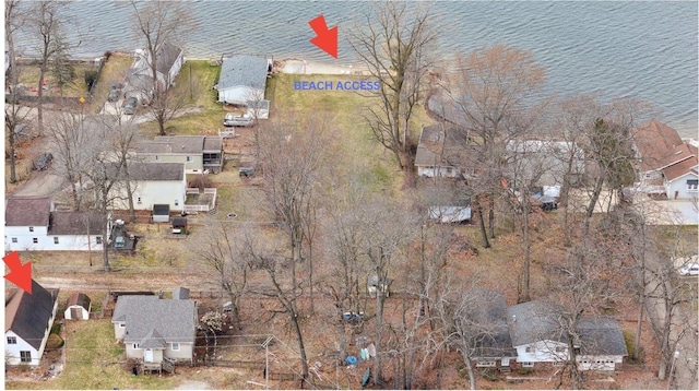 drone / aerial view featuring a water view and a residential view