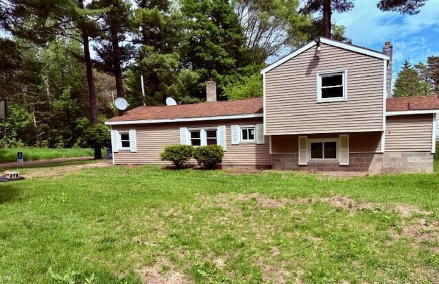 5425 E Tyler Rd, Walkerville, MI 49459 - back of house featuring a chimney and a lawn