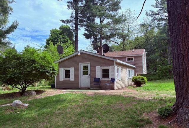 5425 E Tyler Rd, Walkerville, MI 49459 - back of house with a lawn