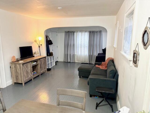 1024 Madison St, Muskegon, MI 49442 - living area featuring a wealth of natural light, wood finished floors, and arched walkways