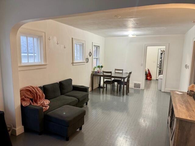 1024 Madison St, Muskegon, MI 49442 - living room with arched walkways, baseboards, visible vents, and wood-type flooring