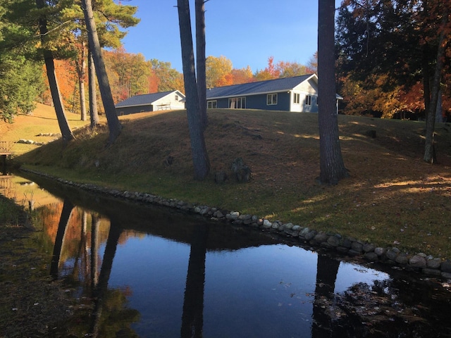 exterior space with a water view and a yard