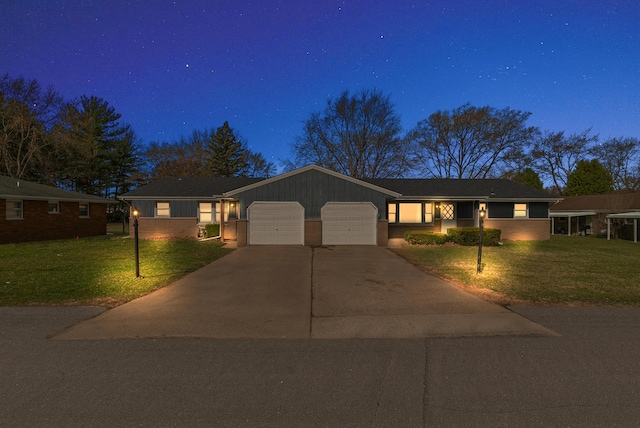 ranch-style home featuring an attached garage, a front lawn, and concrete driveway