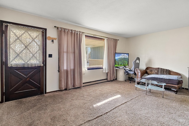 carpeted living area featuring a baseboard radiator and baseboards