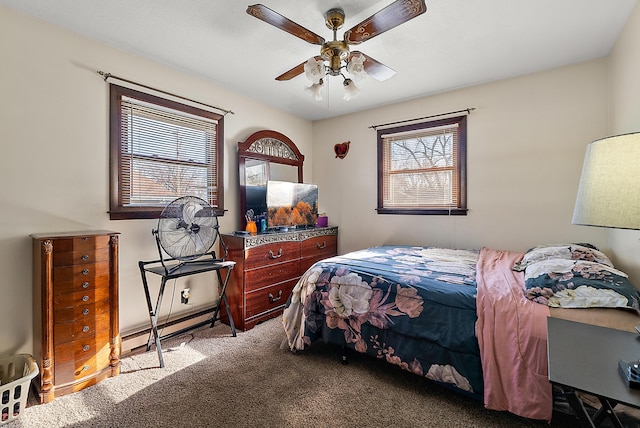 bedroom with carpet flooring, ceiling fan, and baseboard heating