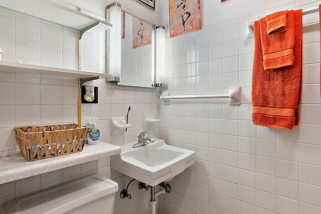 bathroom with tile walls, toilet, and tasteful backsplash