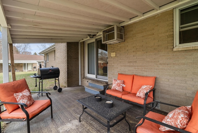 view of patio / terrace with area for grilling, an AC wall unit, outdoor lounge area, and entry steps