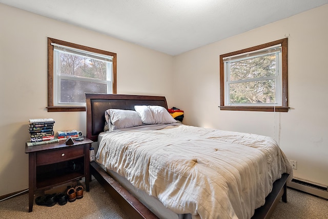 carpeted bedroom with baseboard heating