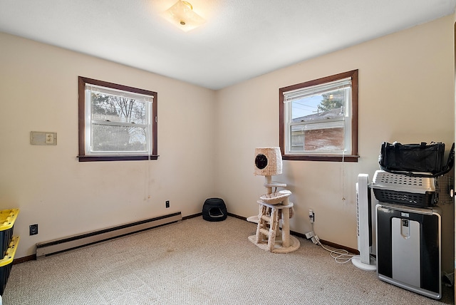 misc room featuring a baseboard radiator, carpet, and baseboards