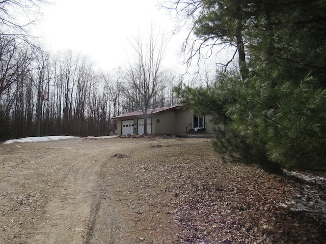 view of yard featuring driveway and an attached garage