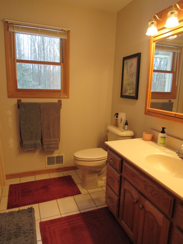 bathroom featuring tile patterned floors, visible vents, toilet, and vanity