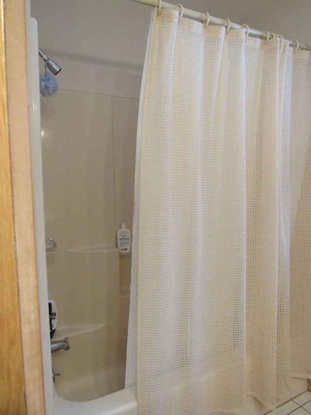 bathroom featuring shower / tub combo and tile patterned flooring