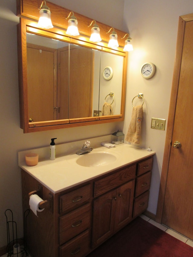 bathroom featuring tile patterned flooring and vanity