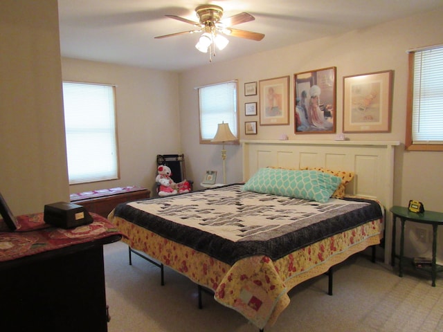 bedroom featuring light colored carpet and ceiling fan