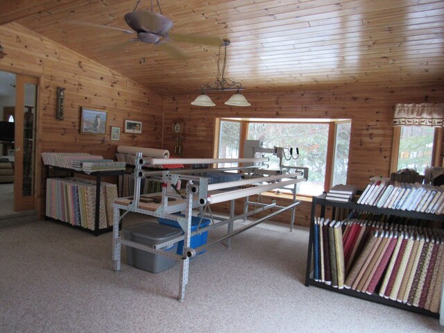 interior space featuring lofted ceiling, carpet flooring, wood walls, and wood ceiling