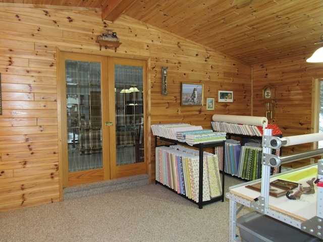 interior space with vaulted ceiling with beams, wood walls, french doors, and wooden ceiling