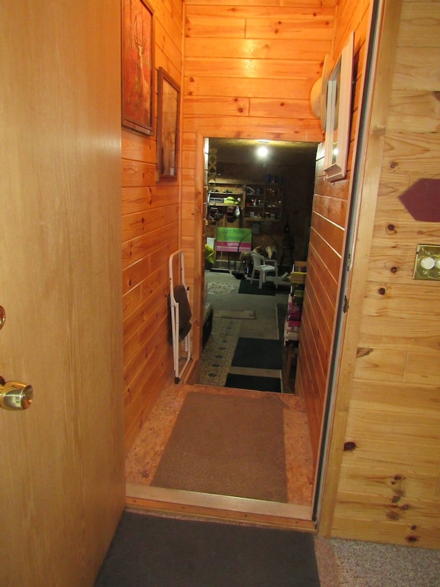 corridor featuring wooden walls