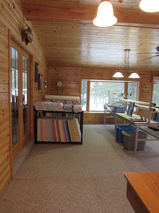 bedroom featuring french doors, wood ceiling, wood walls, and carpet
