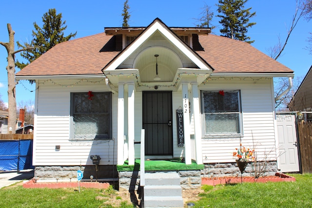 1702 Copeman Blvd, Flint, MI 48504 - bungalow featuring roof with shingles and fence