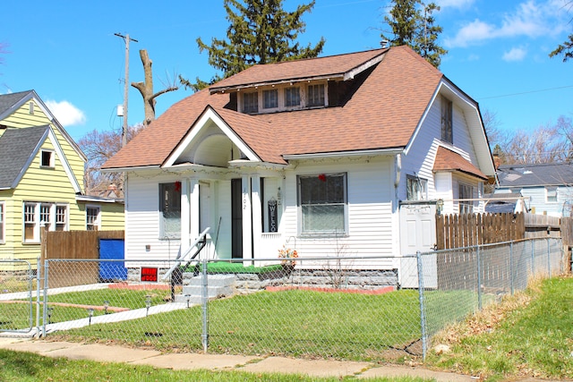 1702 Copeman Blvd, Flint, MI 48504 - bungalow-style house featuring a fenced front yard, a gate, roof with shingles, and a front lawn
