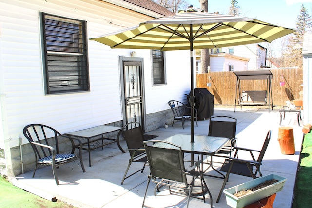 1702 Copeman Blvd, Flint, MI 48504 - view of patio featuring outdoor dining area and fence