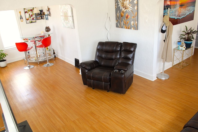 1702 Copeman Blvd, Flint, MI 48504 - living area with arched walkways, baseboards, and wood finished floors