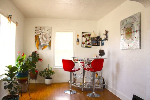 1702 Copeman Blvd, Flint, MI 48504 - dining room with baseboards, plenty of natural light, and wood finished floors