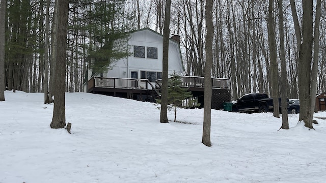 12181 Trail Creek Dr, Stanwood, MI 49346 - snow covered house with a chimney and a deck