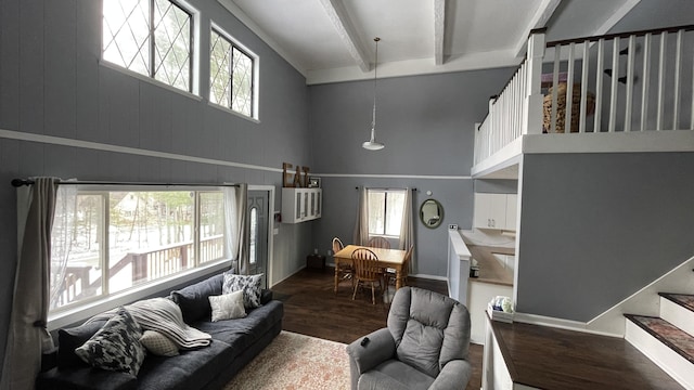 12181 Trail Creek Dr, Stanwood, MI 49346 - living room with beam ceiling, a healthy amount of sunlight, stairs, and wood finished floors