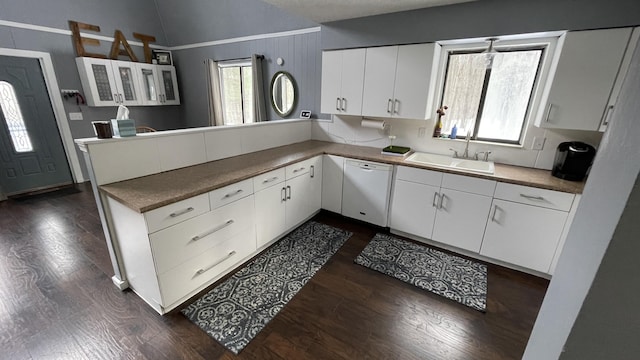 12181 Trail Creek Dr, Stanwood, MI 49346 - kitchen with a sink, white dishwasher, a peninsula, and dark wood finished floors