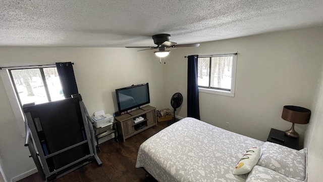 12181 Trail Creek Dr, Stanwood, MI 49346 - bedroom featuring a textured ceiling, dark wood-style floors, and ceiling fan