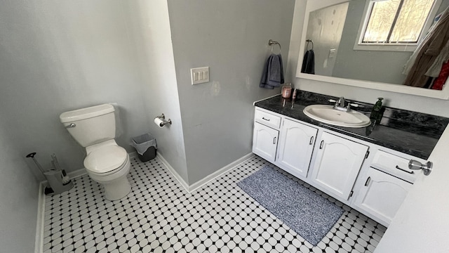 12181 Trail Creek Dr, Stanwood, MI 49346 - bathroom with baseboards, toilet, vanity, and tile patterned floors