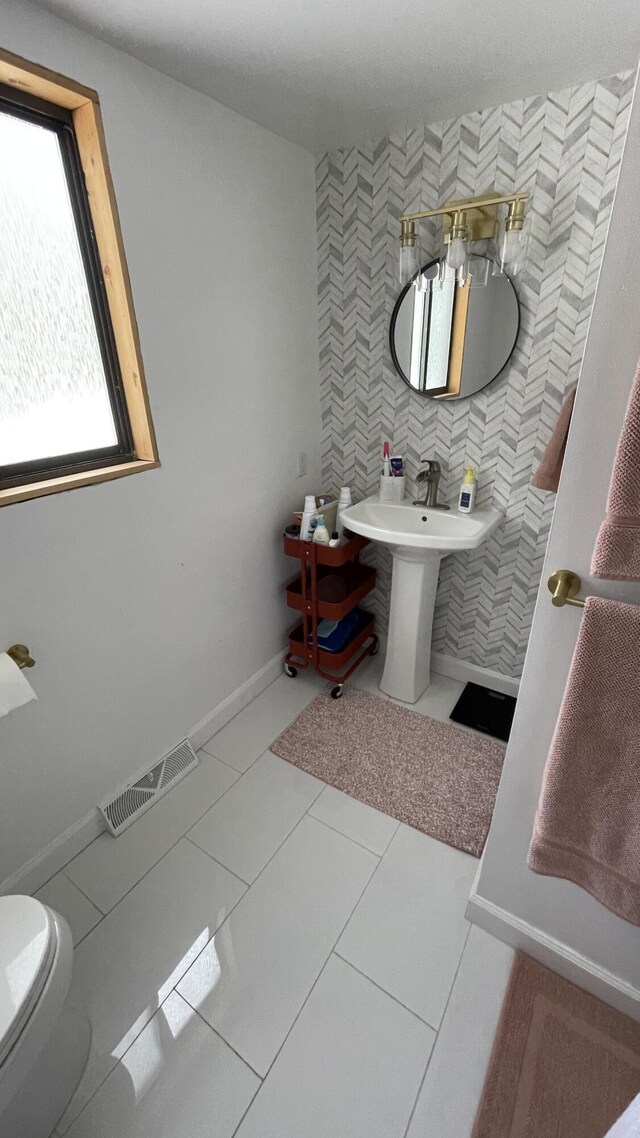 12181 Trail Creek Dr, Stanwood, MI 49346 - half bath with tile patterned flooring, tile walls, toilet, a sink, and visible vents