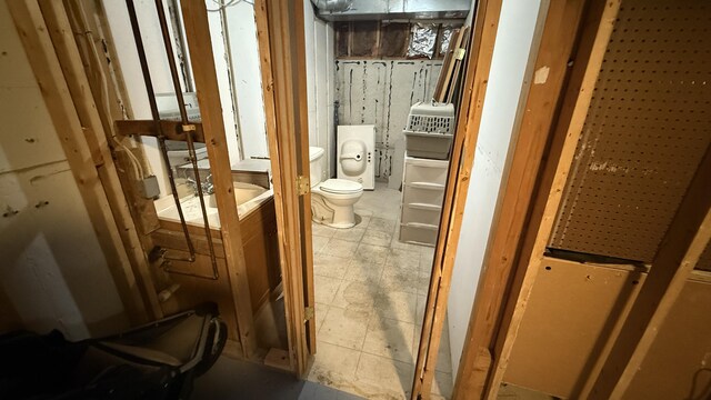 12181 Trail Creek Dr, Stanwood, MI 49346 - bathroom featuring washer / clothes dryer and toilet