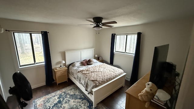 12181 Trail Creek Dr, Stanwood, MI 49346 - bedroom with a ceiling fan, dark wood-style flooring, and baseboards